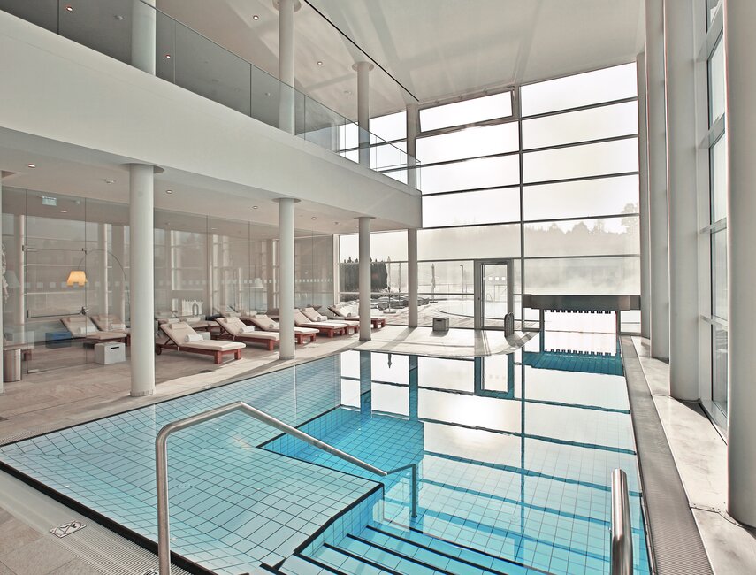 Geinberg5 Private Spa mit Indoor-Pool, Liegen, weißen Säulen und großen Glasflächen | © Spa Resort Geinberg / Gregor Hartl