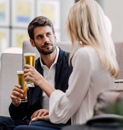 Paar mit Biergläsern in moderner Lounge